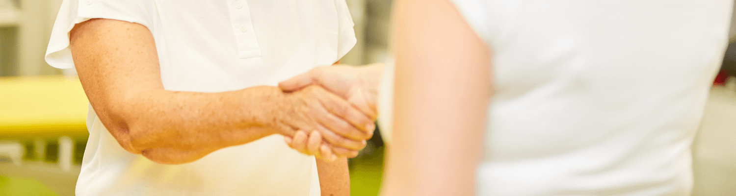 Two women shaking hands after an appointment