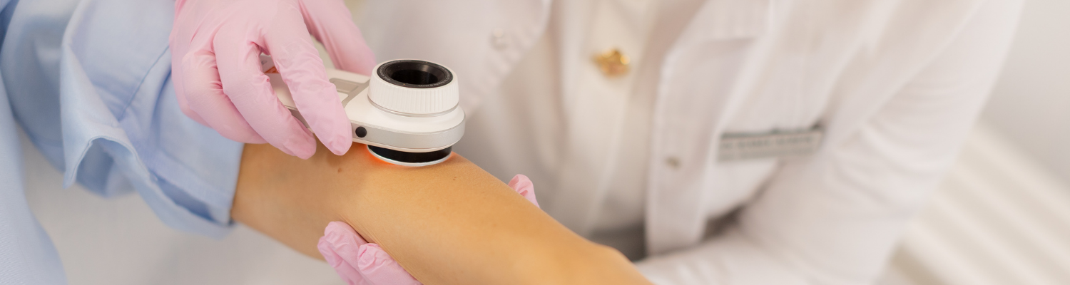 doctor inspecting patients arm for skin cancer